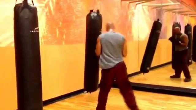 'Kickboxing cardio workout on punching bag at LA Fitness'